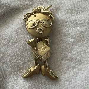 Gold teacher pin- head is moveable.